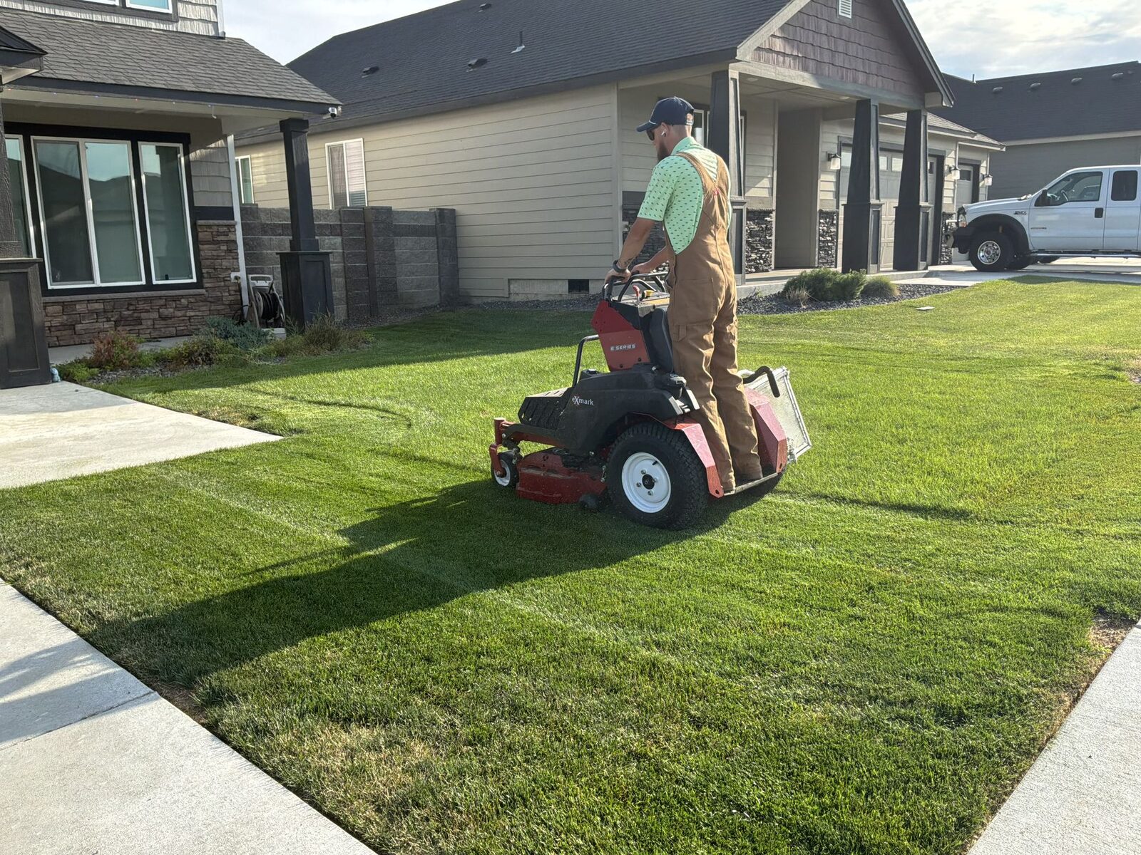 A freshly mowed, striped lawn at golden hour